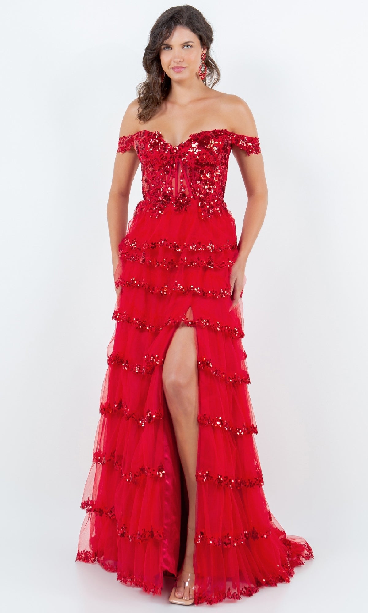A woman poses against a white background, wearing the Cinderella Couture 8228J Ruffle Prom Ball Gown—an elegant, floor-length red dress with sequin embroidery, off-the-shoulder design, and a dramatic front slit.